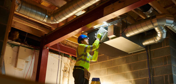 repairman servicing or fixing an outdoor airconditioner unit